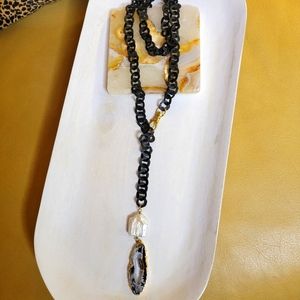 Black lariat chain link necklace with mother of pearl and Druzy drop gold clasp.
